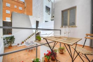 a balcony with a table and glasses on it at Amilcar House by Slow Villas in Palma de Mallorca