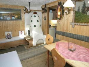 a dining room with a table and a toy cow on the wall at Chalet in caroles with a nearby forest in Karrösten