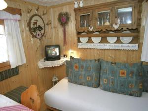 a bedroom with a bed and a tv in it at Chalet in caroles with a nearby forest in Karrösten