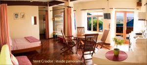 a living room with a table and chairs and a room at Solar Windelo in Mindelo