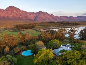 an aerial view of a resort with a lake and mountains at Bartholomeus Klip Farmhouse in Hermon