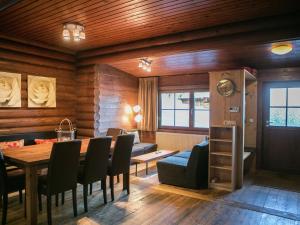 a dining room with a table and chairs at Cosy chalet in Tyrol with a private garden in Hopfgarten im Brixental