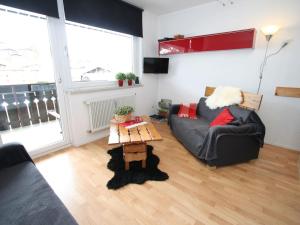 a living room with a couch and a table at Apartment in Maria Alm directly on the ski slopes in Maria Alm am Steinernen Meer