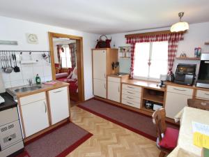 a kitchen with white cabinets and a sink at Austrian chalet in Bramberg with sauna in Bramberg am Wildkogel