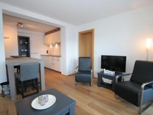 a living room with a couch and chairs and a television at Apartment in Westendorf Tyrol with terrace in Westendorf