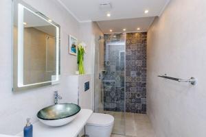 a bathroom with a sink and a toilet and a shower at Apartment Rose Dubrovnik in Dubrovnik