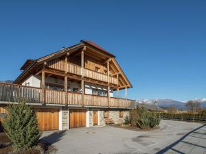 a large wooden house with a large balcony at Chalet in Mauterndorf with sauna in ski area in Mauterndorf