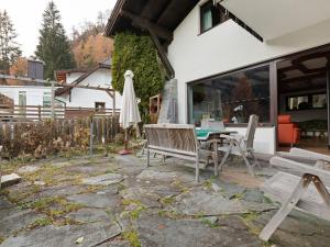 a patio with a table and an umbrella at Chalet in Mallnitz in Carinthia near ski area in Mallnitz