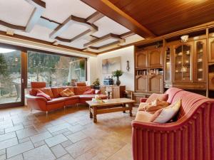 a living room with two couches and a table at Chalet in Mallnitz in Carinthia near ski area in Mallnitz