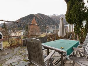 a table and chairs and an umbrella on a patio at Chalet in Mallnitz in Carinthia near ski area in Mallnitz