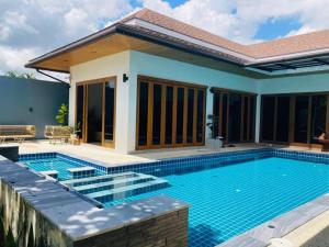 a swimming pool in front of a house at 5 Bedroom Private Pool Villa in Krabi town