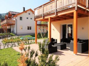 a house with a deck and a patio at Chalet in Carinthia near ski area in Kötschach