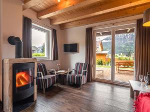 a living room with a fireplace and a balcony at Chalet in Carinthia near ski area in Kötschach