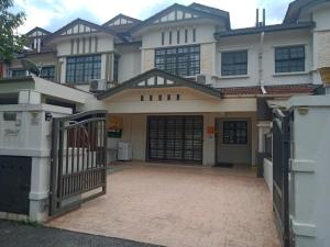 a house with a gate in front of it at Cosy P6 Homestay in Puchong