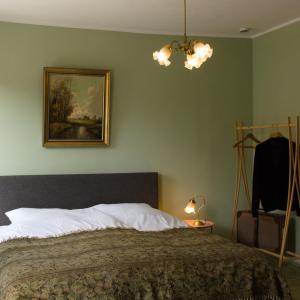 a bedroom with a bed and a painting on the wall at Ferienwohnung Reinette in Lippoldsberg +12 photos