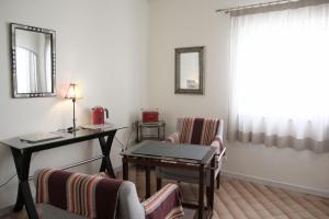 a waiting room with a table and chairs and a desk at Angela Guest House in Lagos