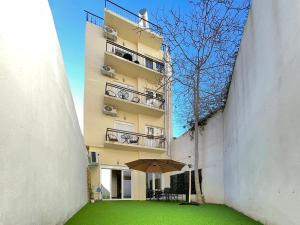 an umbrella in the courtyard of a building at SOHO Modern 55sqm Studio with Secret Garden in Athens