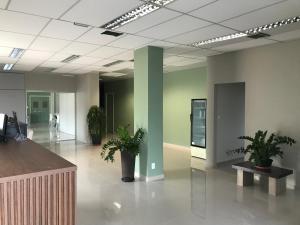 an empty lobby with potted plants in a building at Pratico Hotel in Santarém