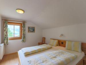 a bedroom with two beds and a window at Cosy holiday home near ski area in Piesendorf