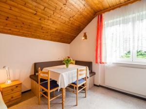 a dining room with a table and chairs and a window at Apartment in Tr polach Carinthia with pool in Tröpolach