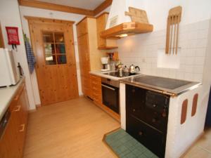 a small kitchen with a stove and a sink at Apartment in Huettschlag near the ski slopes in Karteis