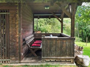 ArriachにあるHoliday home in Arriach near Lake Ossiachの木造キャビン(ベランダにベンチ付)