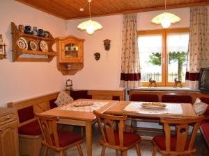 a kitchen and dining room with a table and chairs at Renovated holiday home in the mountains in Pruggern