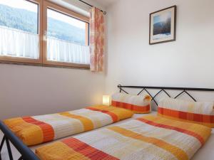 two beds sitting next to each other in a bedroom at Nice apartment at Sonnenkopf in a natural paradise in Dalaas