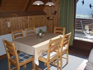 a dining room with a table and chairs and a window at Holiday home in Jenig Carinthia with pool in Jenig