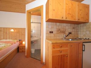 a small bathroom with a sink and a bed at Splendid Apartment in Schladming with Sauna in Schladming