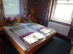 two twin beds in a room with two windows at Apartment at Nassfeld in Carinthia in Sonnenalpe Nassfeld
