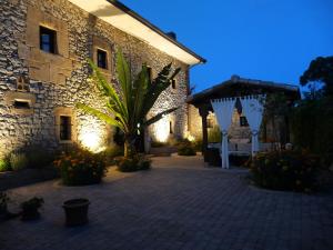 a courtyard of a stone building with a pavilion at Posada El Pozo in Castanedo