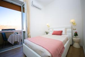 A bed or beds in a room at Viale Italia Boutique Rooms