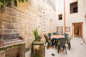 a patio with a table and chairs and a fireplace at Casa Melita in Rabat