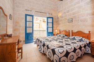 ein Schlafzimmer mit einem Bett und einem großen Fenster in der Unterkunft Casa Melita in Rabat
