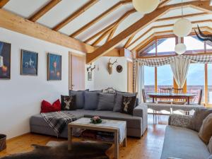 ein Wohnzimmer mit einem Sofa und einem Tisch in der Unterkunft Apartment in Sankt Stefan near Lake Pressegger in Tratten