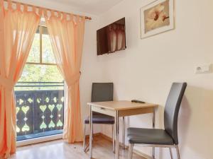 a room with a table and two chairs and a window at Apartment in Styria near bathing lake in Ligist