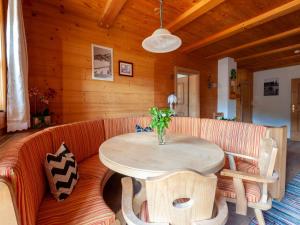 a wooden room with a table and a couch at Beautiful flat in Kirchberg near the ski area in Kirchberg in Tirol