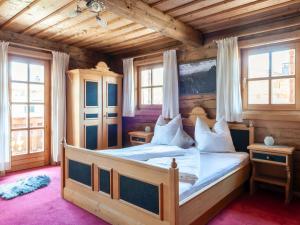 a bedroom with a bed in a wooden house at Beautiful flat in Kirchberg near the ski area in Kirchberg in Tirol