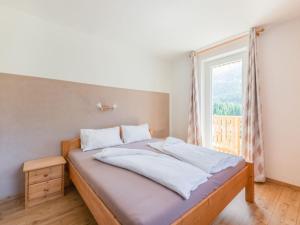 a bed in a room with a large window at Holiday home in Wenns Piller with 3 terraces in Piller