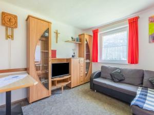 a living room with a couch and a tv at Holiday home in Wenns Piller with 3 terraces in Piller
