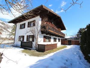 a white house with snow on the ground at Holiday home near Zell am See and Kaprun in Bruck an der Großglocknerstraße