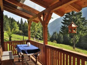 a wooden deck with a table and a light on it at Inviting Chalet in Kolbnitz Teuchl with Garden and Terrace in Penk