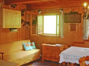 a living room with a couch and a window at Inviting Chalet in Kolbnitz Teuchl with Garden and Terrace in Penk