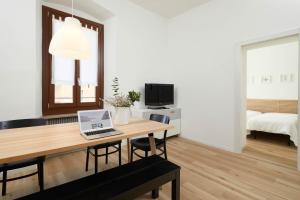 a living room with a desk with a laptop on it at Casa Morellato in Riva del Garda