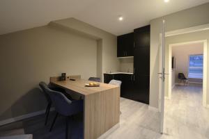 a kitchen and living room with a table and chairs at JustStay Ratingen in Ratingen