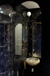 a bathroom with a sink and a mirror at Seasides Paris - Suite Monroe in Le Blanc-Mesnil