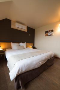 Postel nebo postele na pokoji v ubytování Auberge de Poteaupré