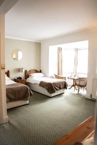 מיטה או מיטות בחדר ב-Tyacks Hotel