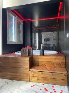 a bathroom with a tub and a sink and a bath tub at Le Seaside - Love Room Jacuzzi et Day Use - Parc des Expos Bourget, CDG 15 min in Le Blanc-Mesnil
